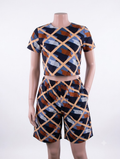 Diamond grid African print matching set — navy, tan, rust and blue crop top and shorts on mannequin