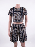 Mudcloth tribal African print matching set — black with white and brown symbols, crop top and shorts on mannequin