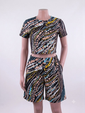 Dot wave African print matching set — black with pink, teal, yellow and white dots, crop top and shorts on mannequin